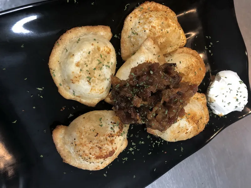 Perogies served with bacon Jam and Sour Cream